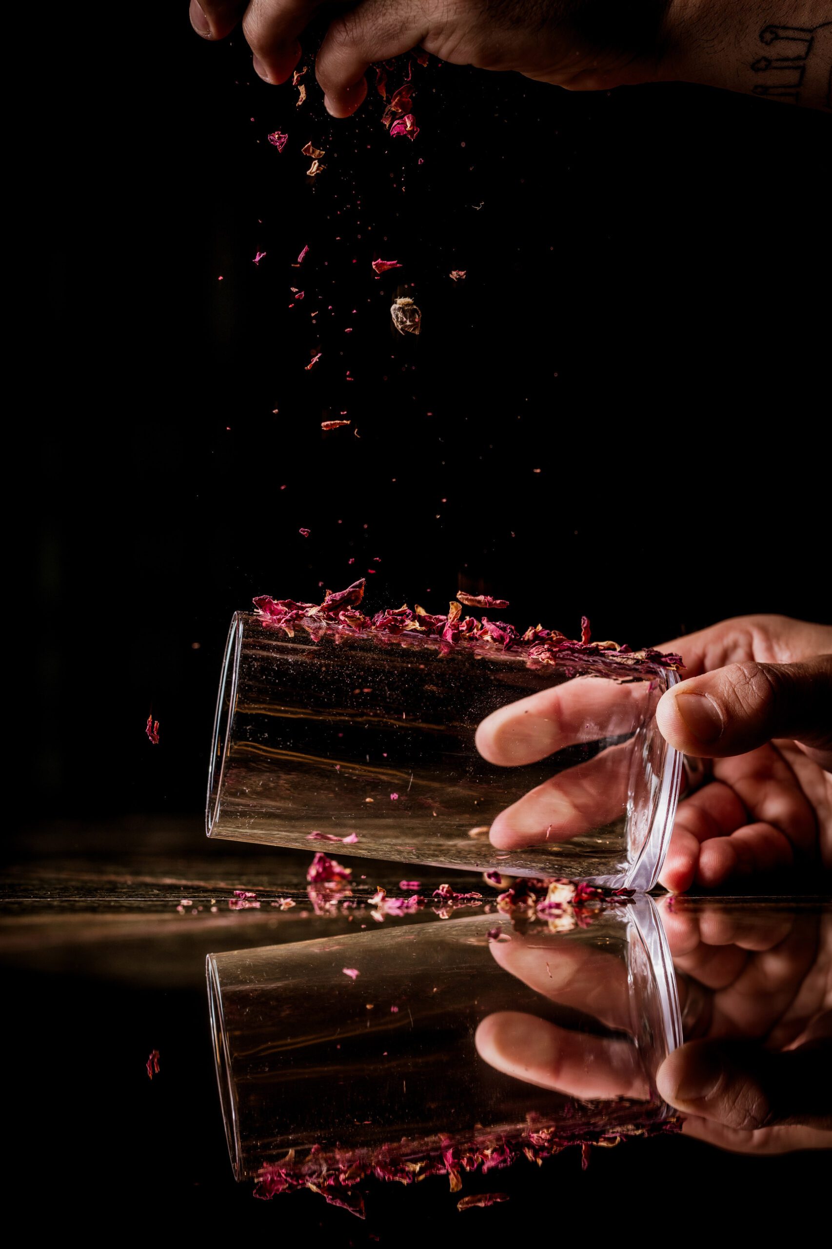 bartender applying petals to our Raspberry Grapefruit cocktail glass at Florattica rooftop London